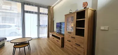 a living room with a table and a entertainment center at Vacansis Valencia Bajo Torrefiel in Valencia