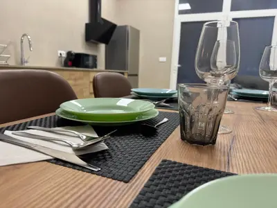 a wooden table with a green plate and a glass at Basset 1 in Valencia