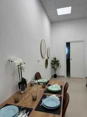a dining room table with plates and wine glasses at Basset 1 in Valencia