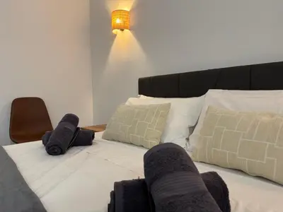 a bedroom with a bed with white sheets and pillows at Basset 1 in Valencia