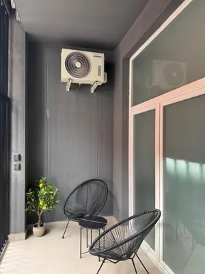 a balcony with two chairs and a tv on the wall at Basset 2 in Valencia