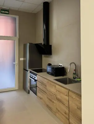 a kitchen with a stainless steel refrigerator and a sink at Basset 3 in Valencia