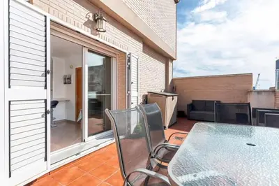 a patio with a table and chairs on a balcony at Acogedor y excelente ubicación in Puerto de Sagunto