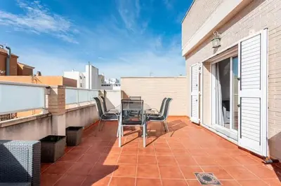 a patio with a table and chairs on a balcony at Acogedor y excelente ubicación in Puerto de Sagunto