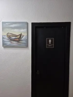 a black door with a picture of a boat on the wall at All you need in Valencia