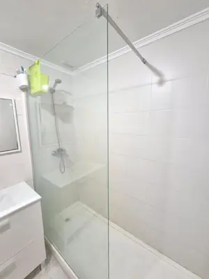 a bathroom with a shower and a glass door at All you need in Valencia