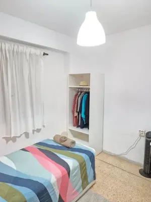 a bedroom with a bed with a colorful blanket at All you need in Valencia