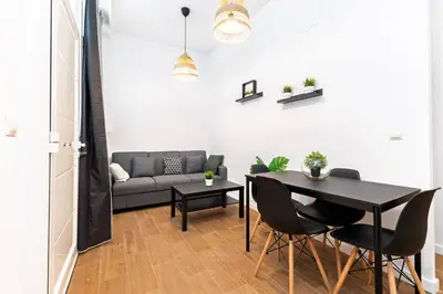 a living room with a table and a couch at Quiet & Modern Apartment in Valencia