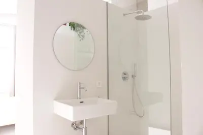 a white bathroom with a sink and a mirror at BNO studio 1c in Aldaia