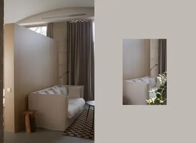 a living room with a white couch and a mirror at BNO studio 1c in Aldaia
