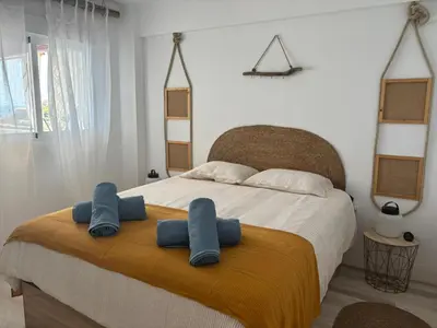 a bedroom with a bed with two towels on it at Faro Cullera Sea view in Faro de Cullera