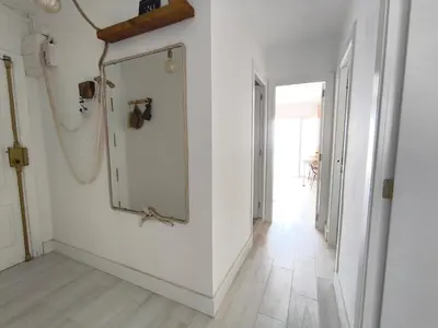 a hallway with a mirror on a wall at Faro Cullera Sea view in Faro de Cullera
