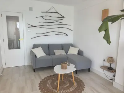 a living room with a couch and a table at Faro Cullera Sea view in Faro de Cullera