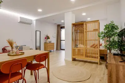 a living room with a table and some chairs at Bright & Modern Apartment - Rose y Maya in Valencia