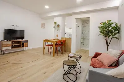a living room with a couch and a table at Bright & Modern Apartment - Rose y Maya in Valencia