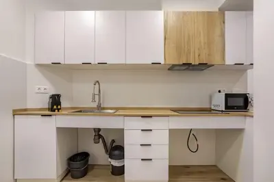 a kitchen with a counter with a sink and a microwave at Bright & Modern Apartment - Rose y Maya in Valencia