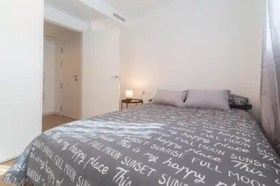 a bedroom with a large bed with white sheets at Historic Center Apartment in Valencia