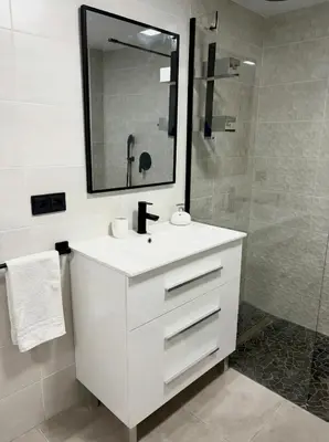 a white bathroom with a sink and a shower at Across from the Turia Modern City Stay in Valencia