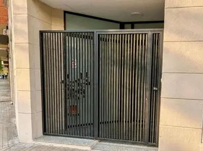 a metal gate on the side of a building at Across from the Turia Modern City Stay in Valencia