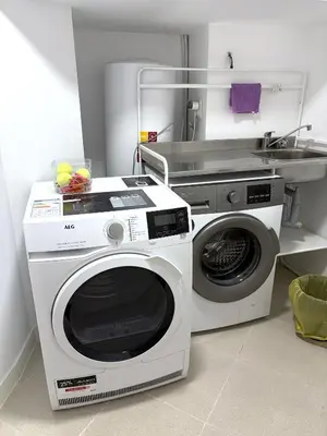 a kitchen with a washing machine and a sink at Across from the Turia Modern City Stay in Valencia