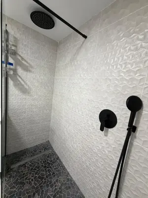 a bathroom with a shower with a shower head at Across from the Turia Modern City Stay in Valencia
