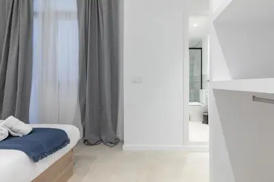 a white room with a bed and a bathroom at My Loft 4 You Democracia I in Valencia