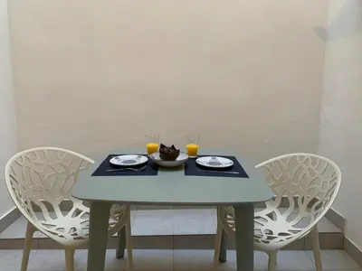 a table with two chairs and a plate of food on it at My Loft 4 You Democracia I in Valencia