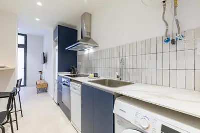 a kitchen with blue cabinets and a sink at My Loft 4 You Democracia I in Valencia