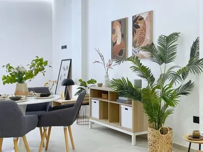 a living room with a table with chairs and plants at Sunny Stay Valencia 4 pax wifi in Valencia