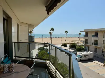 a balcony with a table and a view of the beach at Reinapart Patacona Balcony Seaview in Valencia