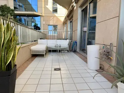 a balcony with couches and a table on a building at Reinapart Patacona Balcony Seaview in Valencia