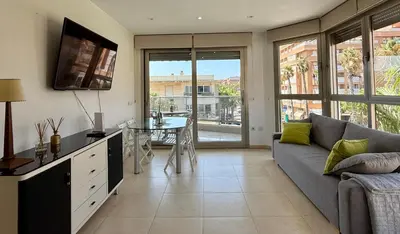a living room with a couch and a table at Reinapart Patacona Balcony Seaview in Valencia