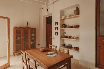 a dining room with a wooden table and shelves at Casa Salvoreta in Valencia