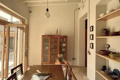a dining room with a table and a cabinet at Casa Salvoreta in Valencia