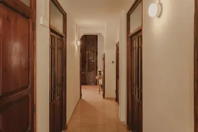 a hallway with wooden doors and a hallway with a table at Casa Salvoreta in Valencia