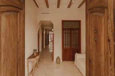 a hallway of a house with a couch and wooden doors at Casa Salvoreta in Valencia