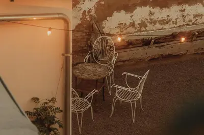 a group of chairs sitting on a balcony with lights at Casa Salvoreta in Valencia