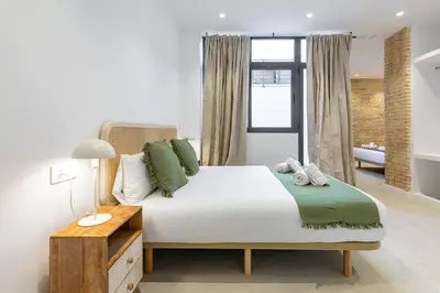 a bedroom with a large bed with green pillows at My Loft 4 You Democracia II in Valencia