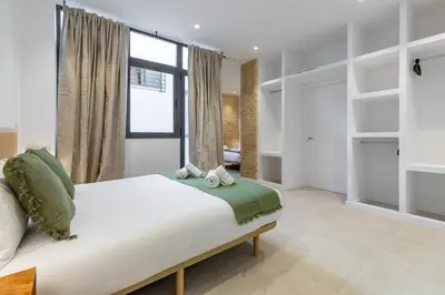 a bedroom with a large bed and a window at My Loft 4 You Democracia II in Valencia