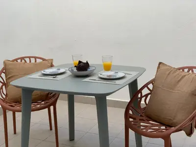 a table with two glasses of orange juice on it with two chairs at My Loft 4 You Democracia II in Valencia