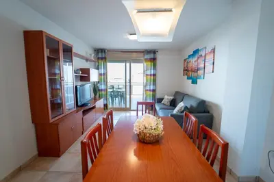 a living room with a wooden table and a couch at Tu rincón frente al mar en Moncofa Ideal para dos in Moncófar