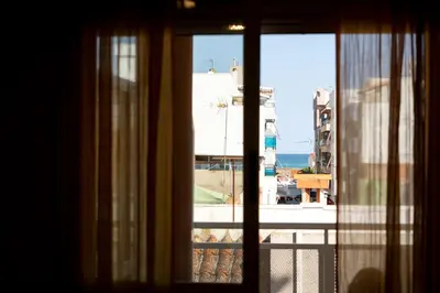 a view of the ocean from a window at Tu rincón frente al mar en Moncofa Ideal para dos in Moncófar