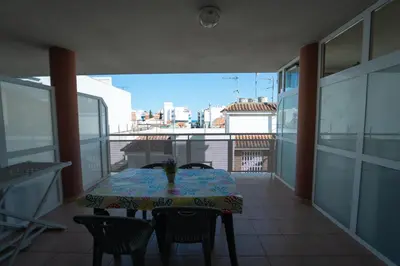 a table on a balcony with a view of the city at Tu rincón frente al mar en Moncofa Ideal para dos in Moncófar