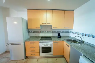 a kitchen with a white refrigerator and a sink at Tu rincón frente al mar en Moncofa Ideal para dos in Moncófar