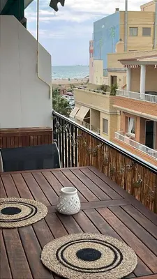 a wooden table with a vase on top of a balcony at District Key - Puerto de Sagunto, Virgen Losar in Puerto de Sagunto