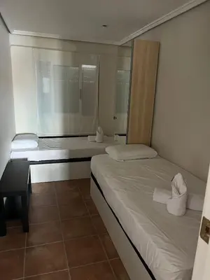 a bedroom with two beds and a window at District Key - Puerto de Sagunto, Virgen Losar in Puerto de Sagunto