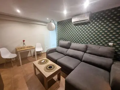 a living room with a couch and a table at District Key - Puerto de Sagunto, Virgen Losar in Puerto de Sagunto