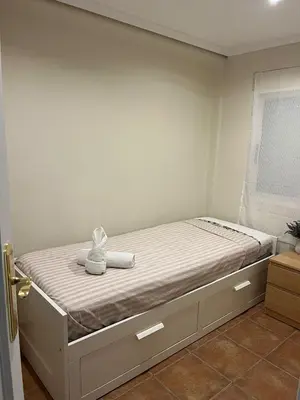 a bedroom with a bed with two towels on it at District Key - Puerto de Sagunto, Virgen Losar in Puerto de Sagunto
