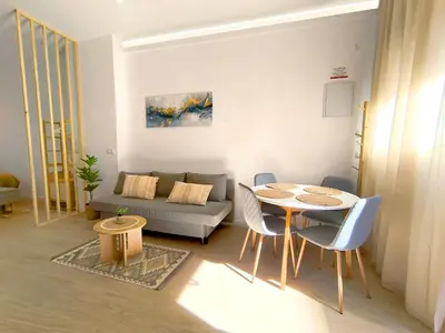 a living room with a table and a couch at The Sunshine Apartment in Valencia