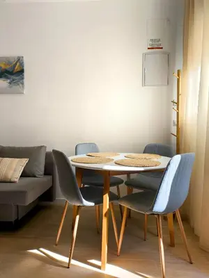 a table and chairs in a living room with a couch at The Sunshine Apartment in Valencia
